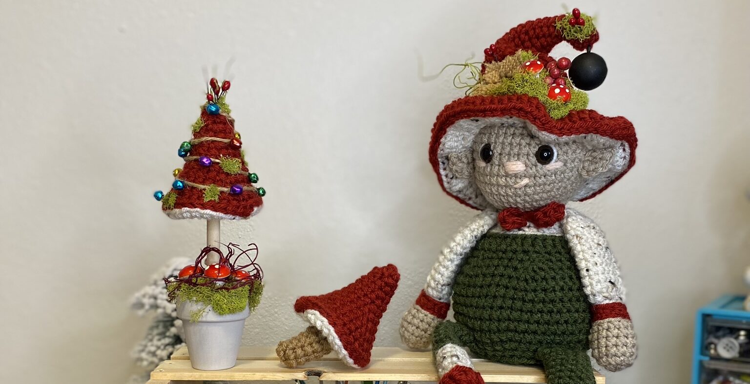 crocheted mushroom Christmas tree with a crochet elf
